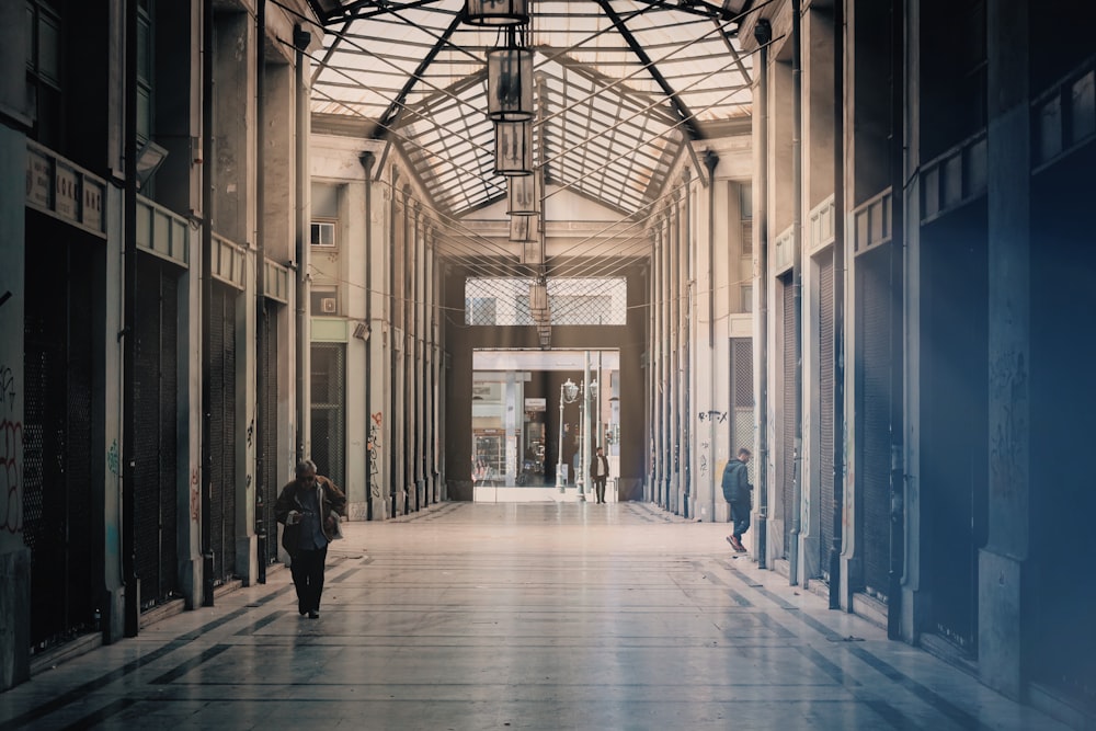 a person walking down a hallway in a building