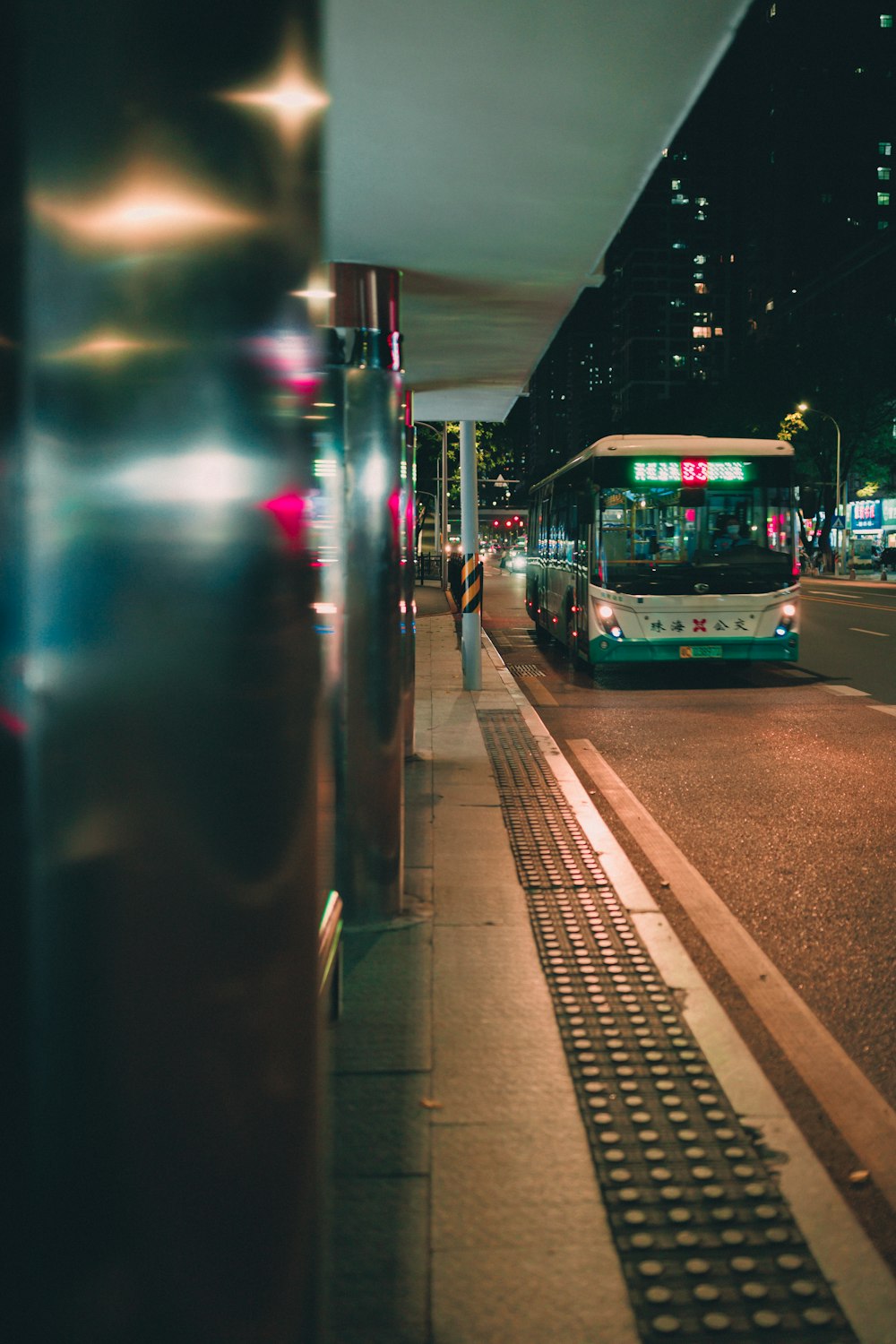 a bus driving down a street next to a tall building