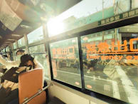 Public transport vehicle windows treated with anti-UV films for passenger comfort.