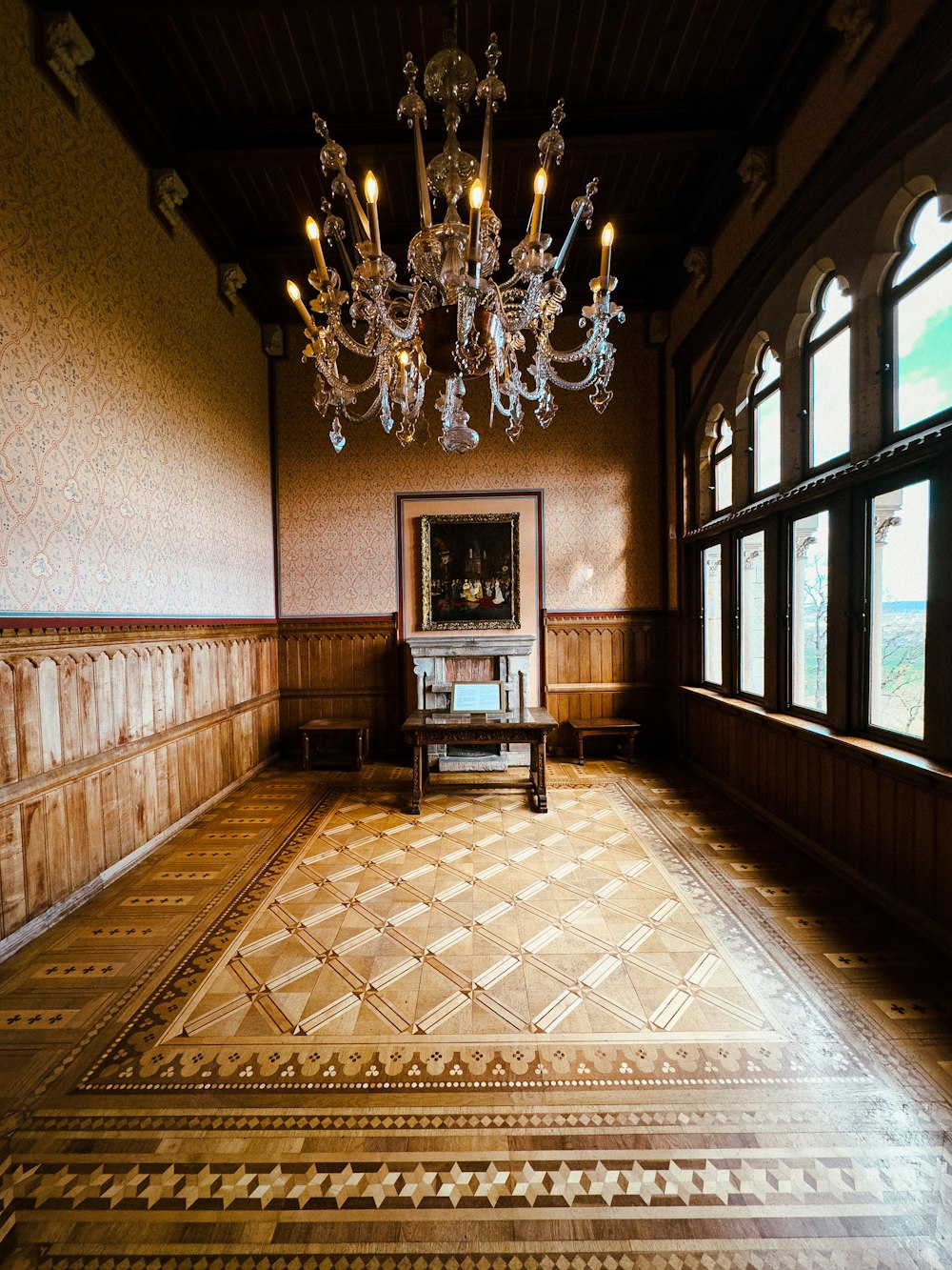 a chandelier hangs from the ceiling in a large room