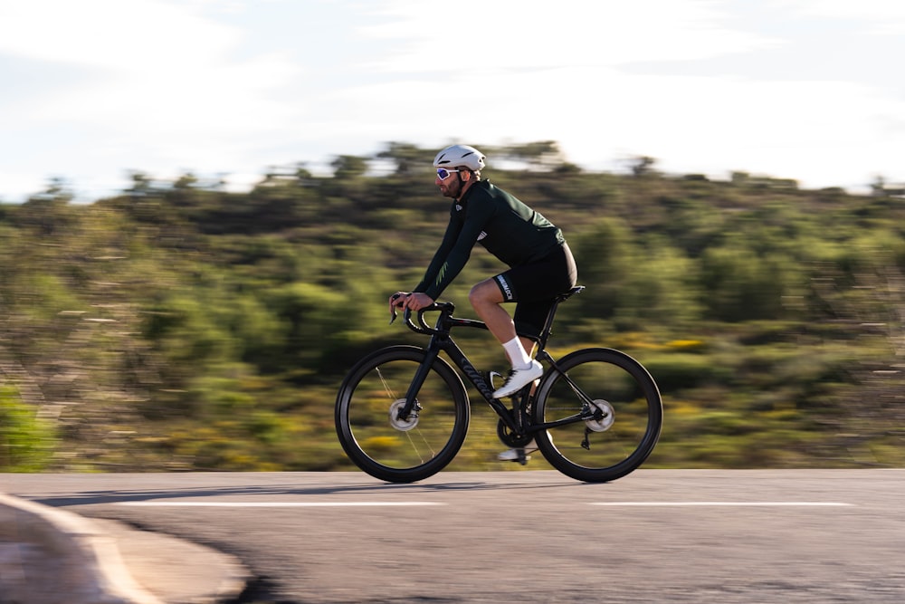 a man riding a bike down a curvy road