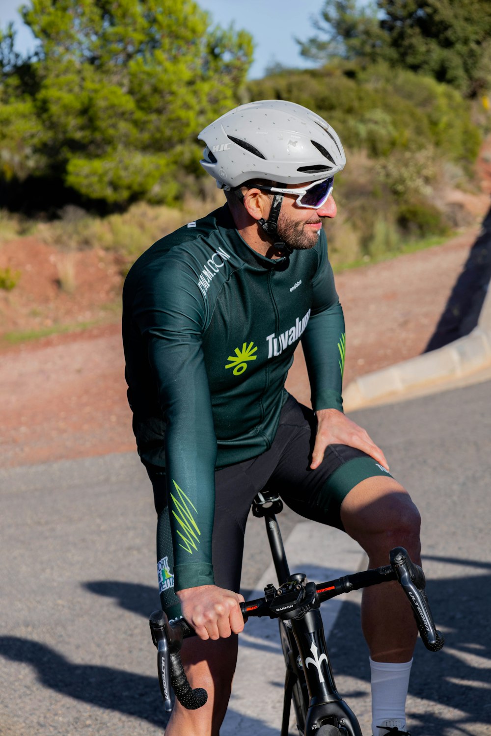 a man riding a bike down a street