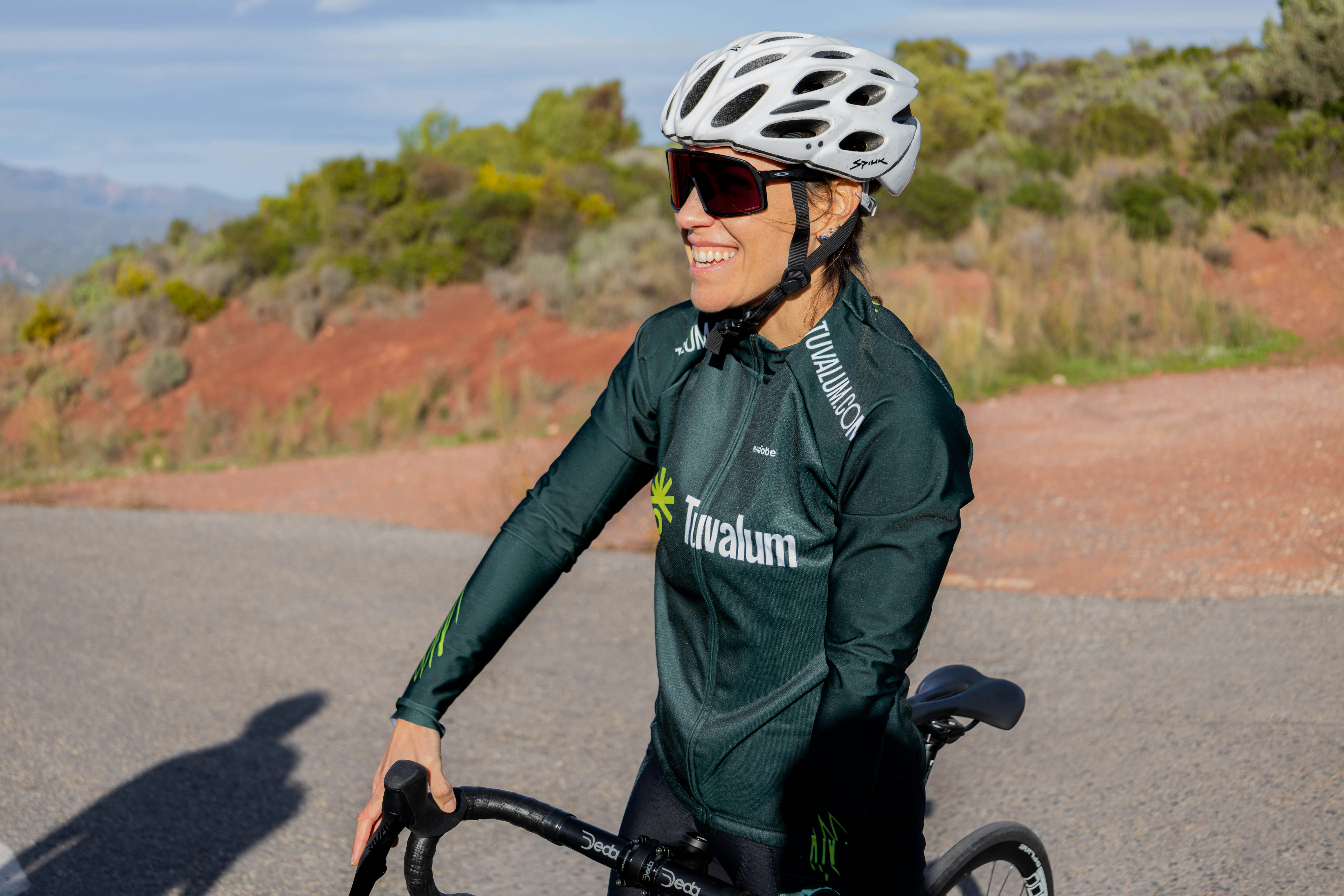 a woman riding a bike down a street