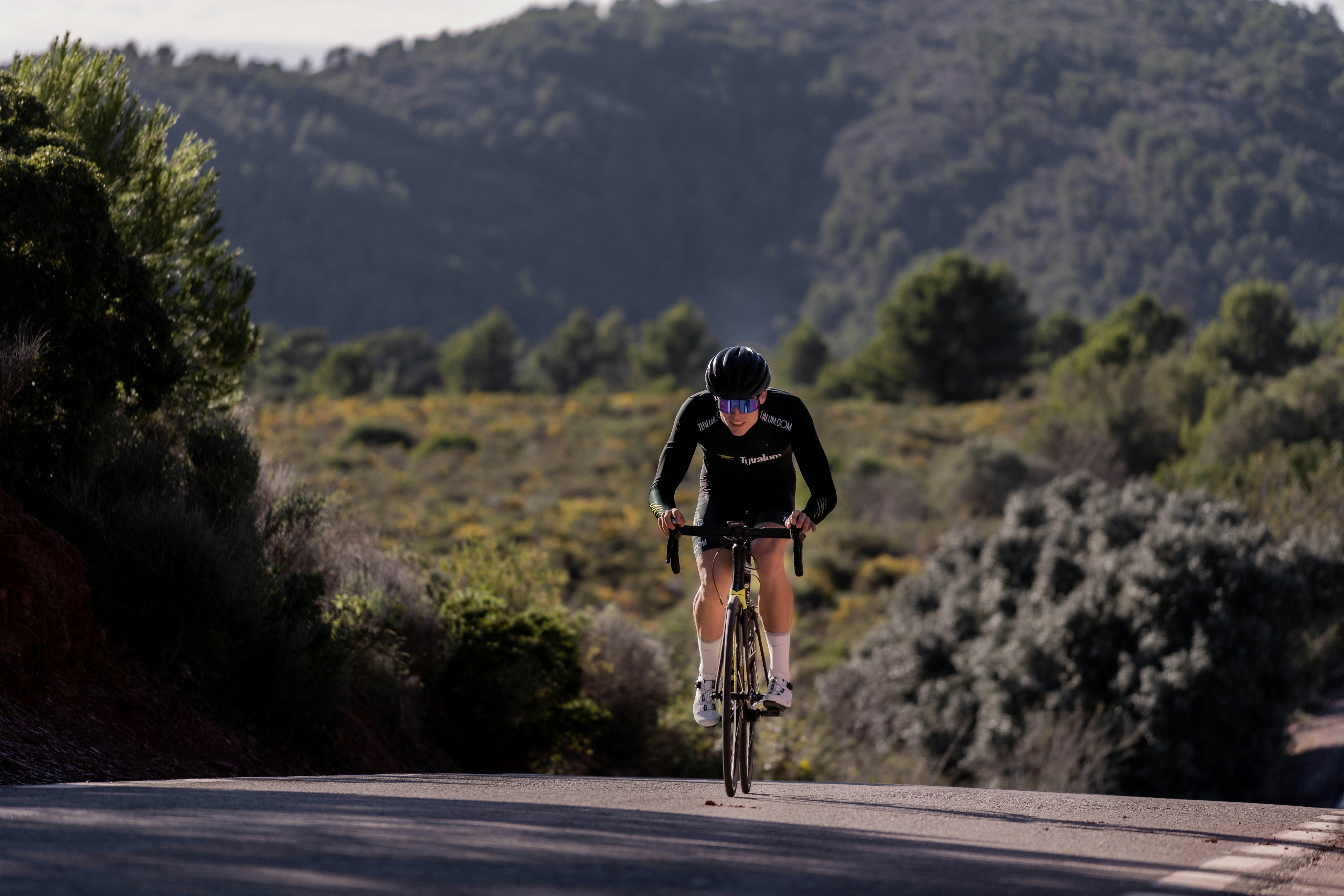 a man riding a bike down a curvy road