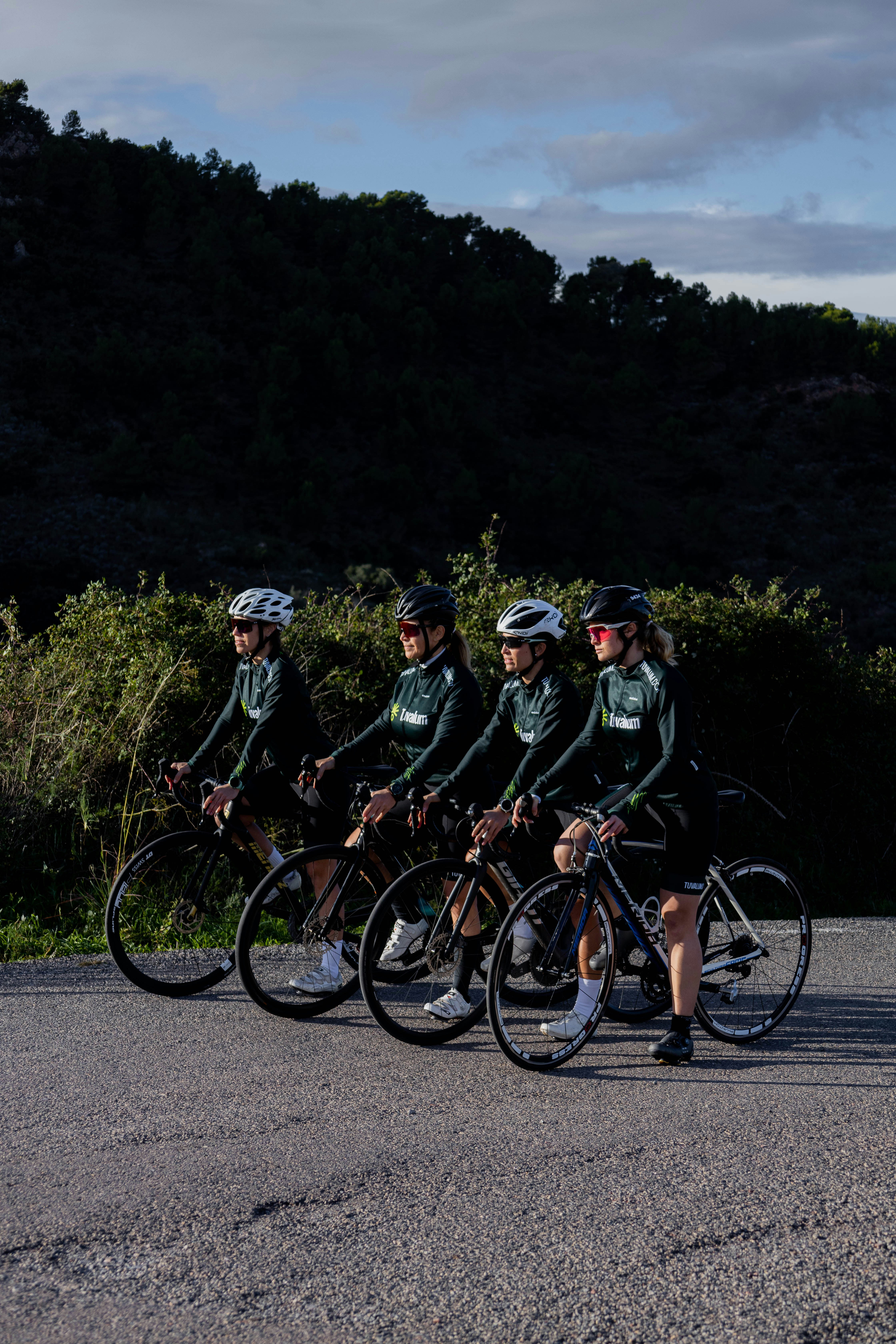 a group of people riding bikes down a street