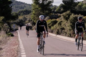 a group of people riding bikes down a road