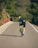 a man riding a bike down a road