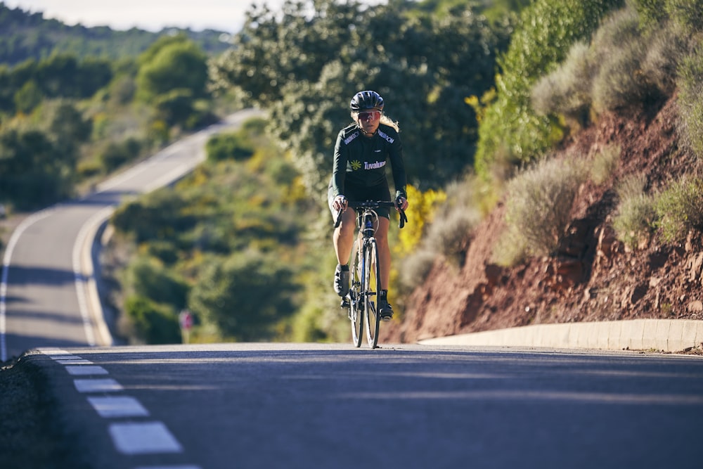 a man riding a bike down a curvy road