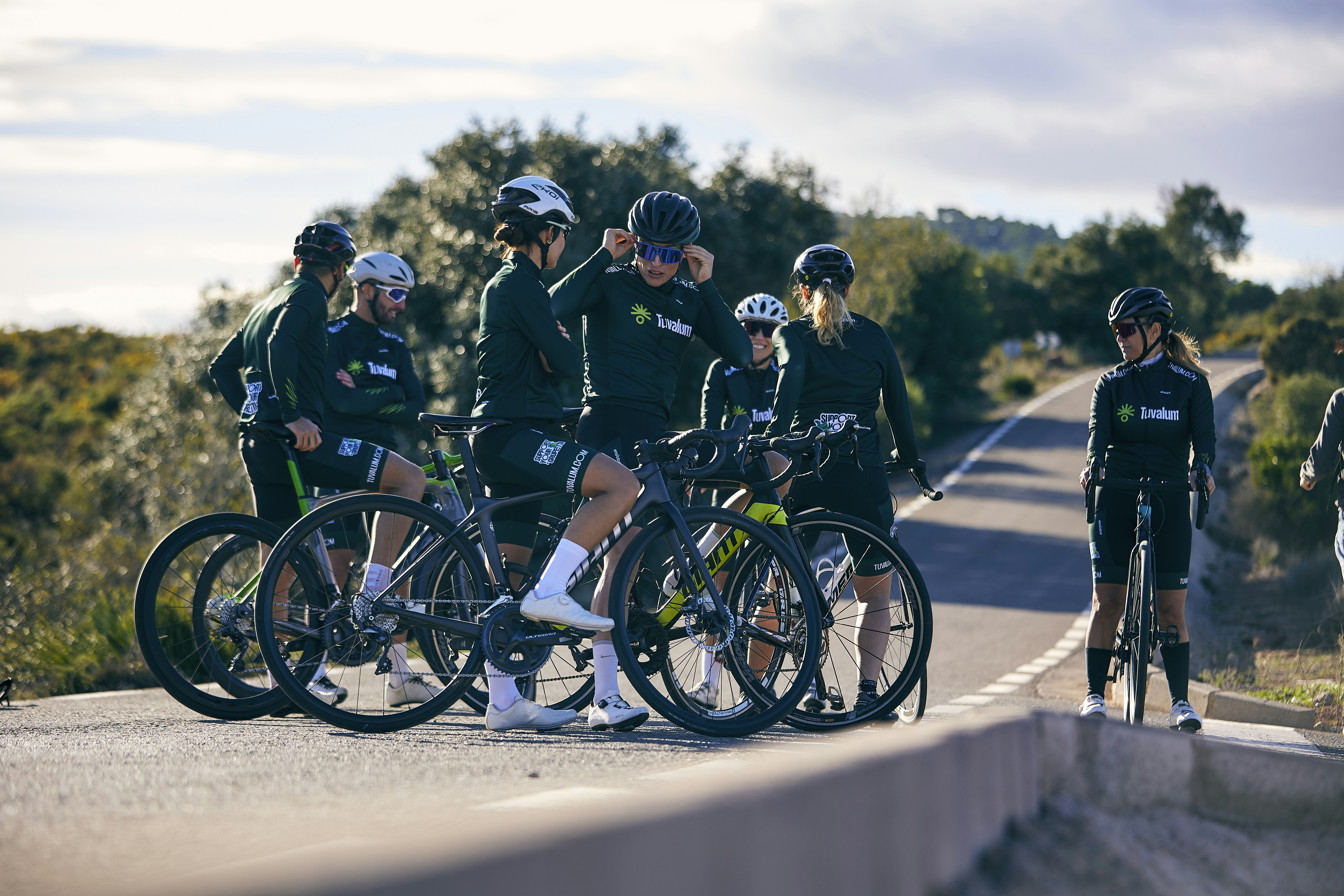 a group of people standing around with their bikes