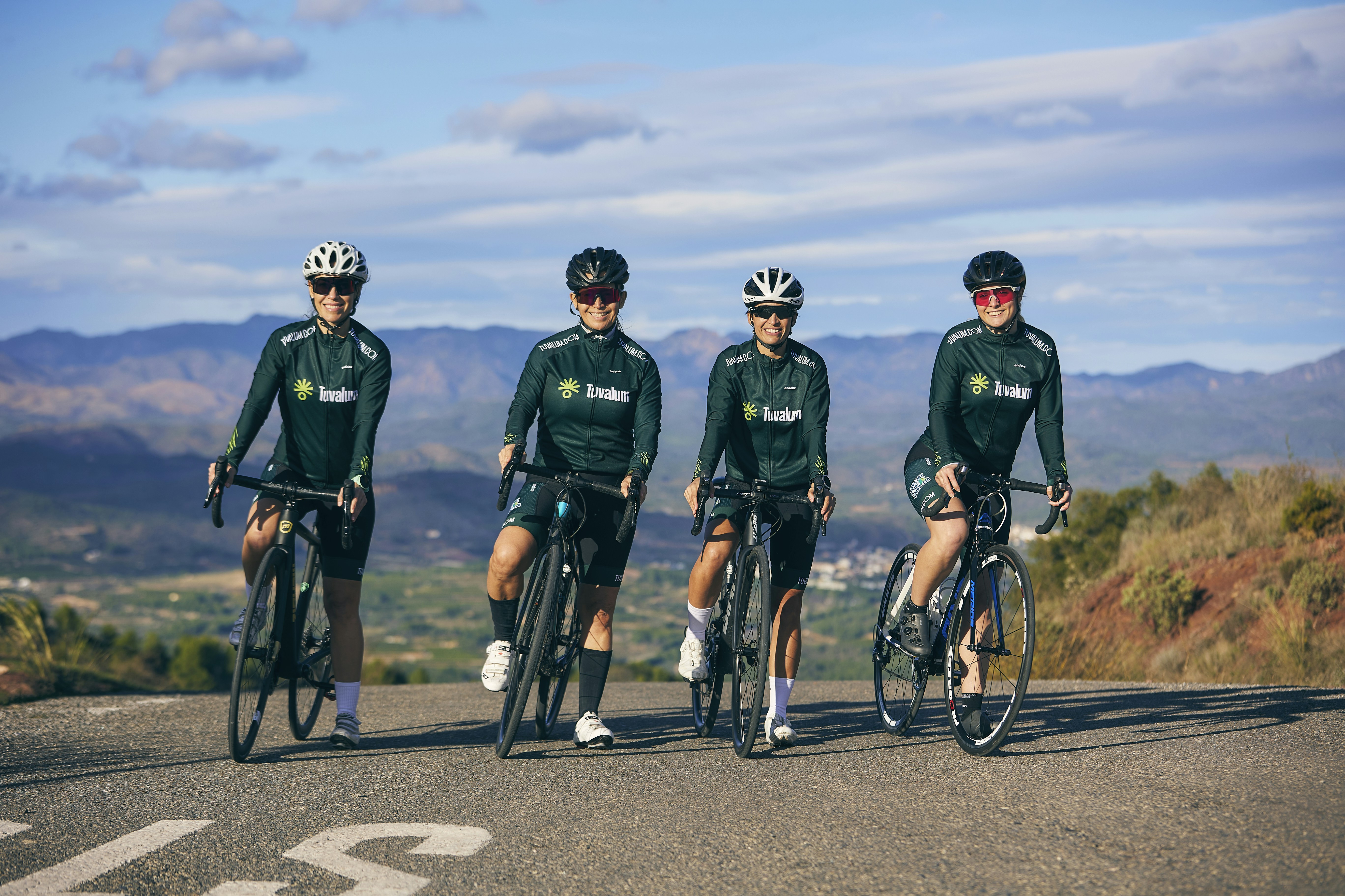a group of people riding bikes down a road