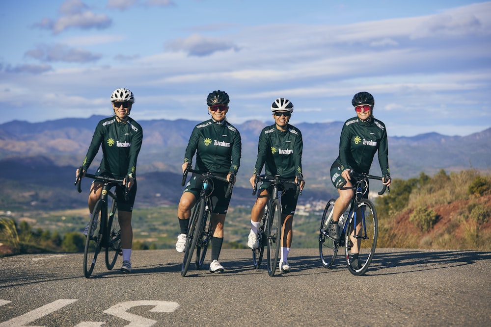 a group of people riding bikes down a road