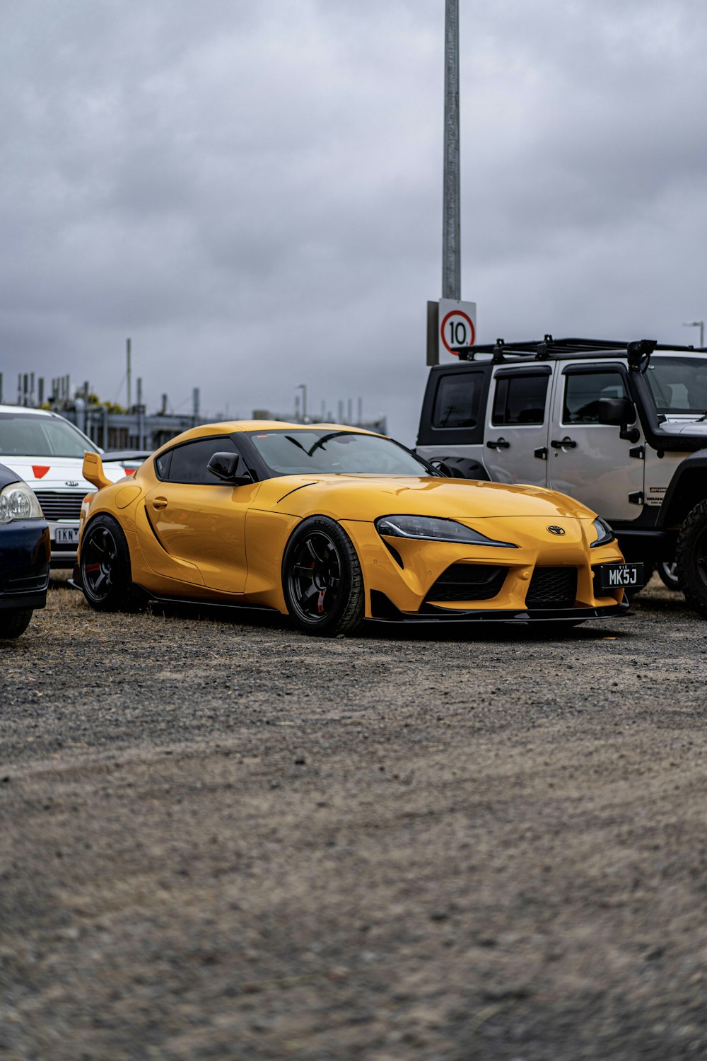 a yellow sports car parked in a parking lot