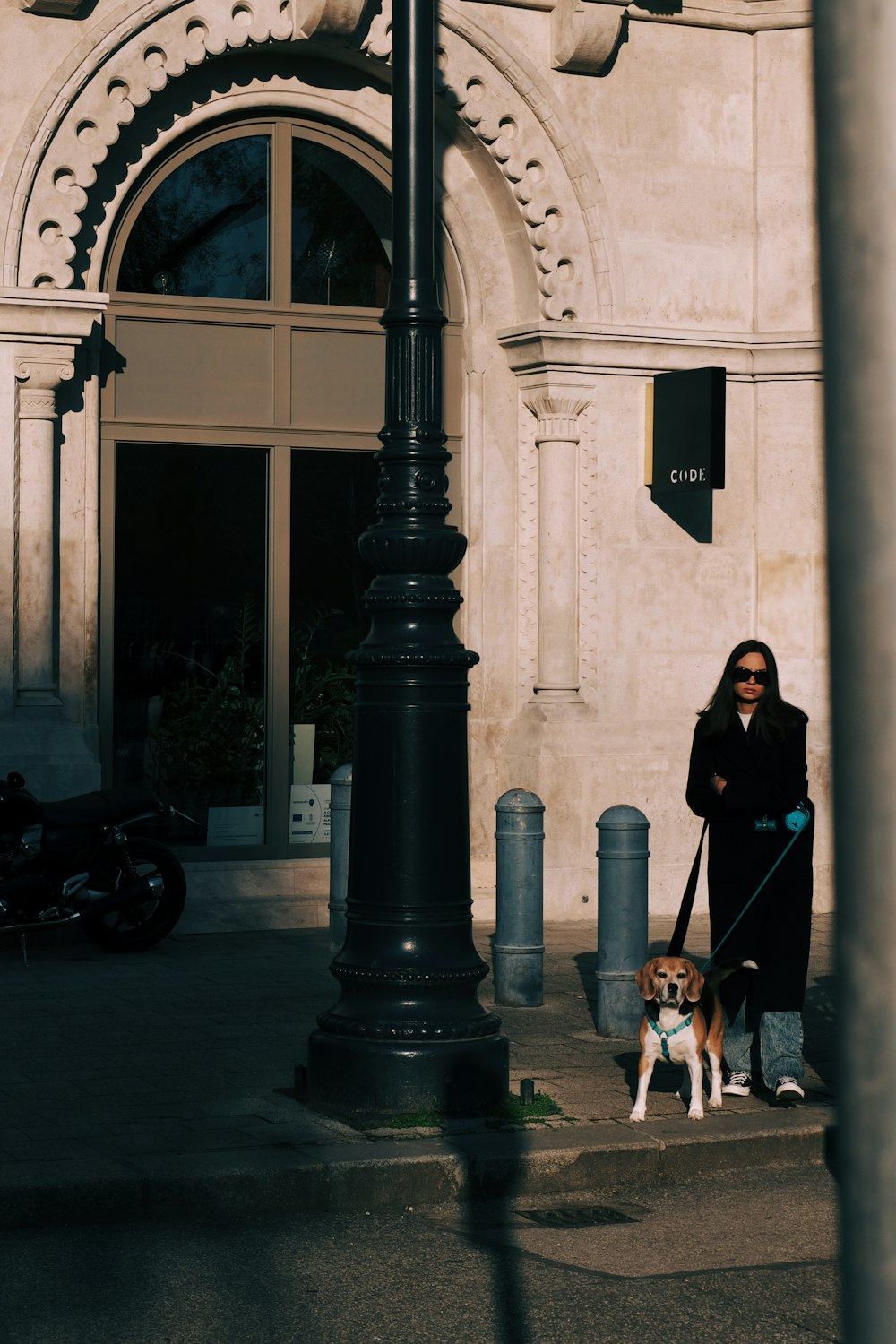 a woman is walking her dog on a leash