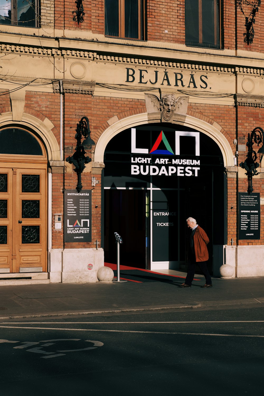 a person walking out of a building with a sign on it