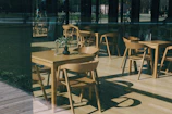 Modern café terrace with minimalist furniture and soft natural light.