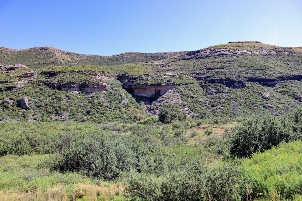 a view of a mountain with a cave in the middle of it