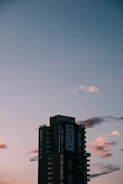Elegant high-rise building silhouette against a charcoal sky.