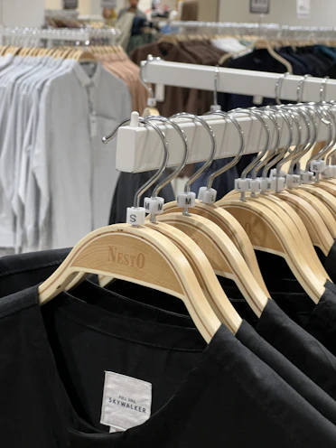 A row of XXL to XXXXXL shirts displayed on a rack highlighting the size inclusivity.