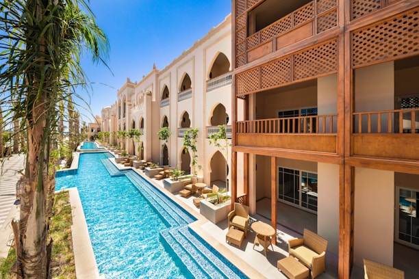 A stunning luxury villa in Kuwait with a spacious pool and elegant outdoor seating.
