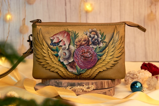 a small purse with flowers painted on it