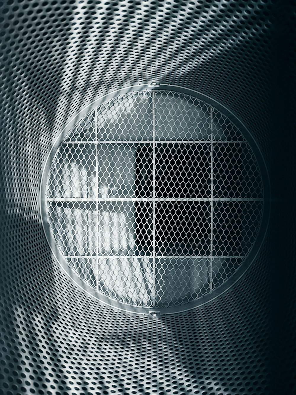 a metal screen with a circular hole in it