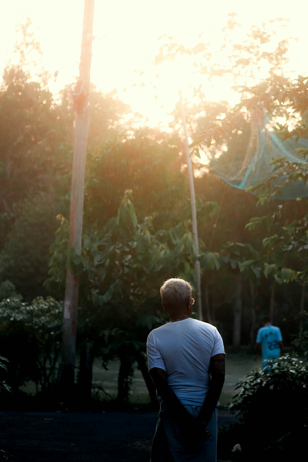 a man standing in a park with a frisbee in his hand