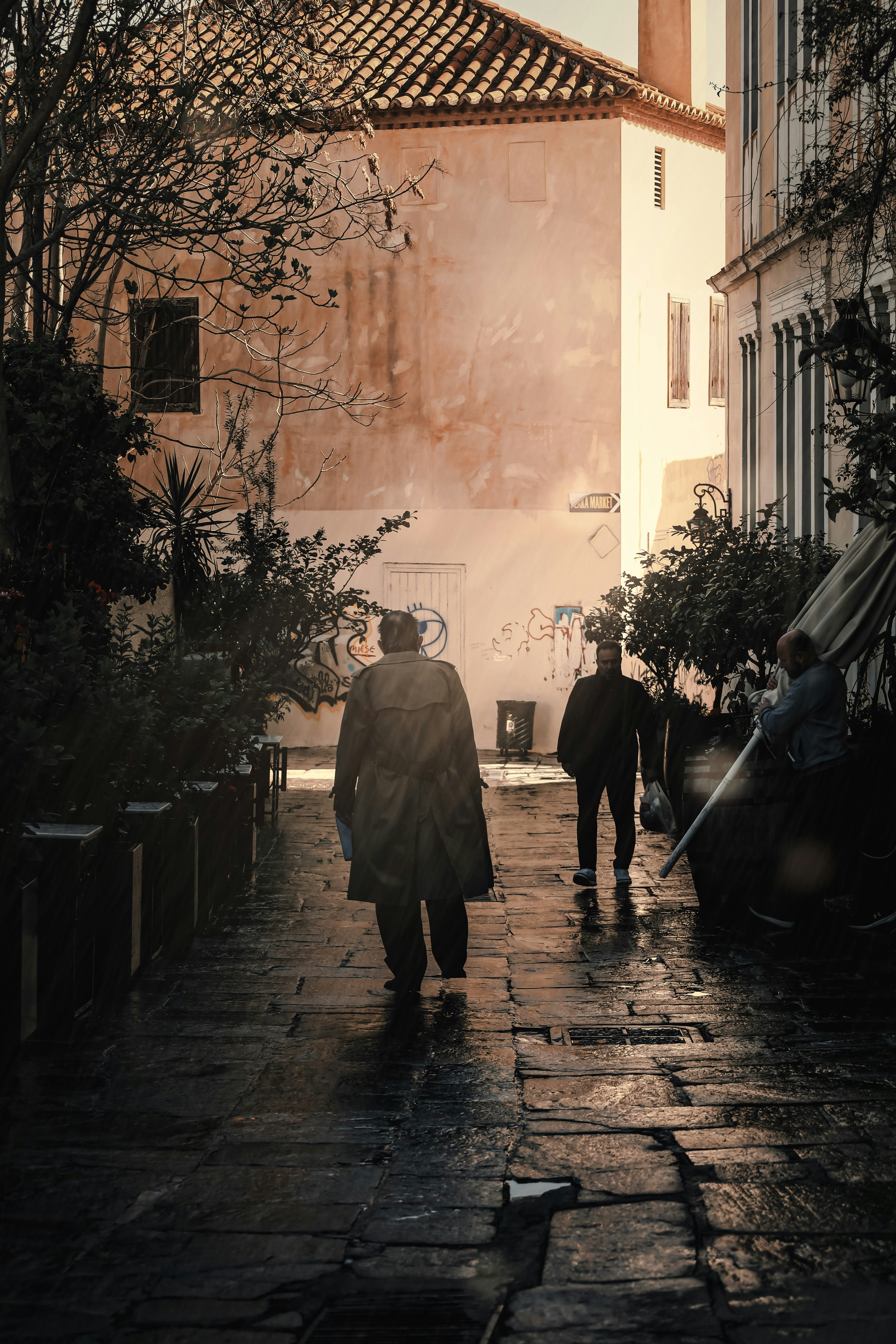 a couple of people walking down a street