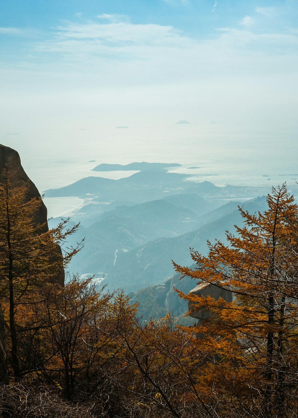 a view of a mountain range with trees in the foreground