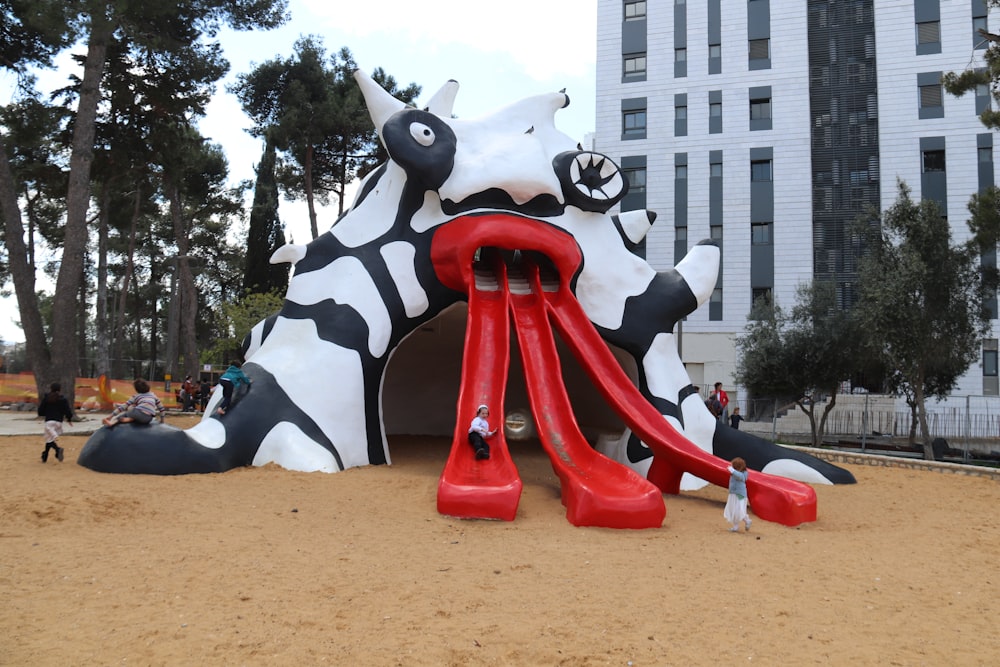 a large inflatable sculpture of a giraffe on a beach