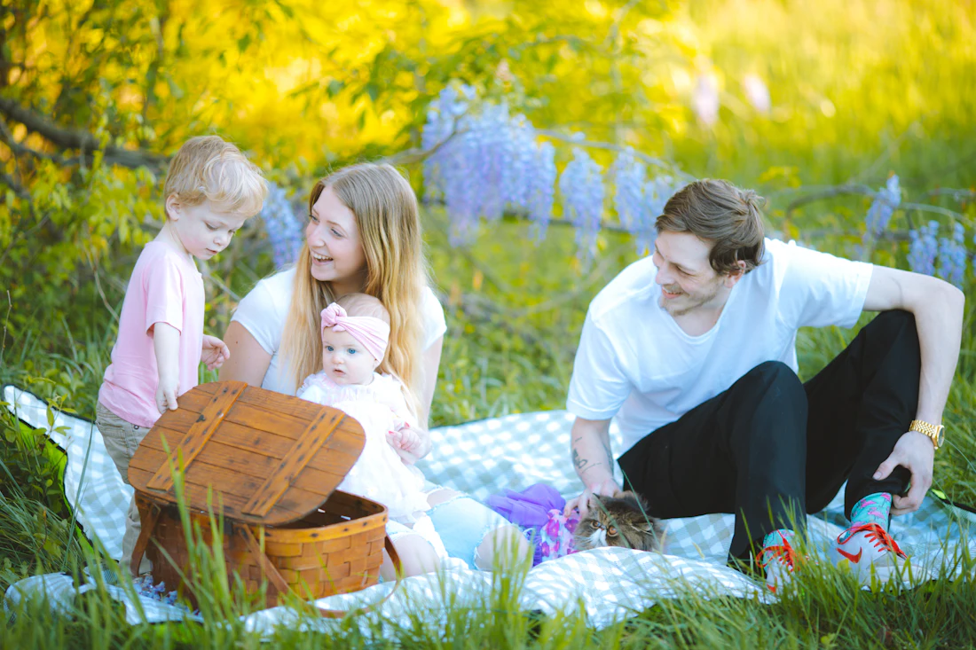 Family picnic with people laughing on grass