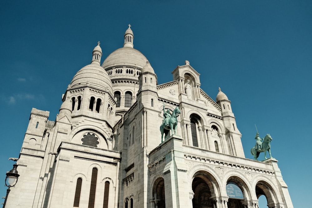 a large white building with a statue on top of it