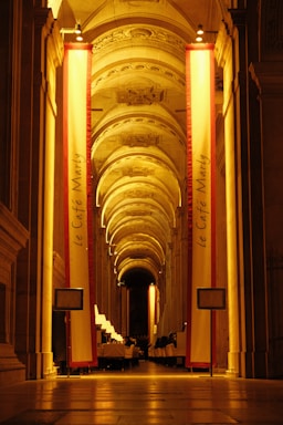 a very long hallway with columns and lights