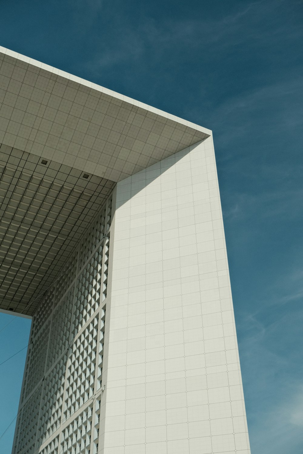 a tall white building with a clock on it's side