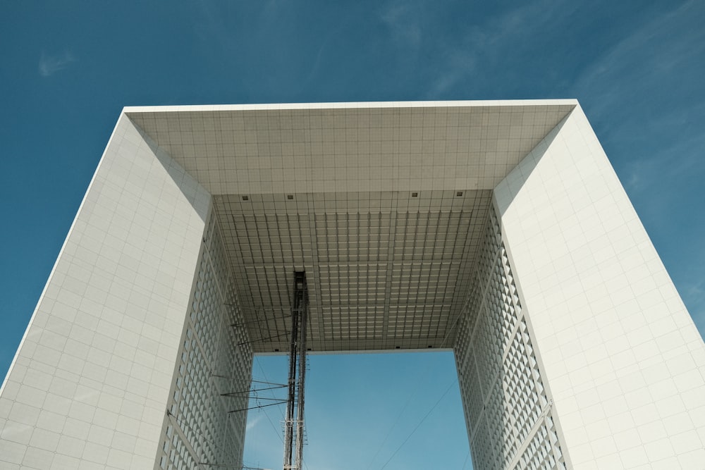 a tall white building with a sky background