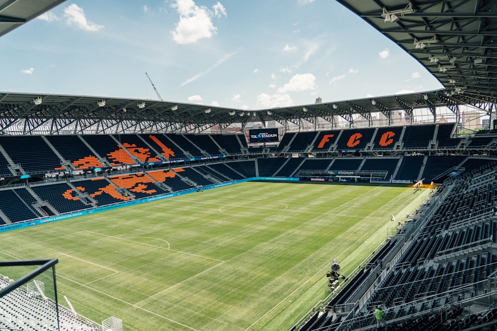 an empty soccer stadium with a green field