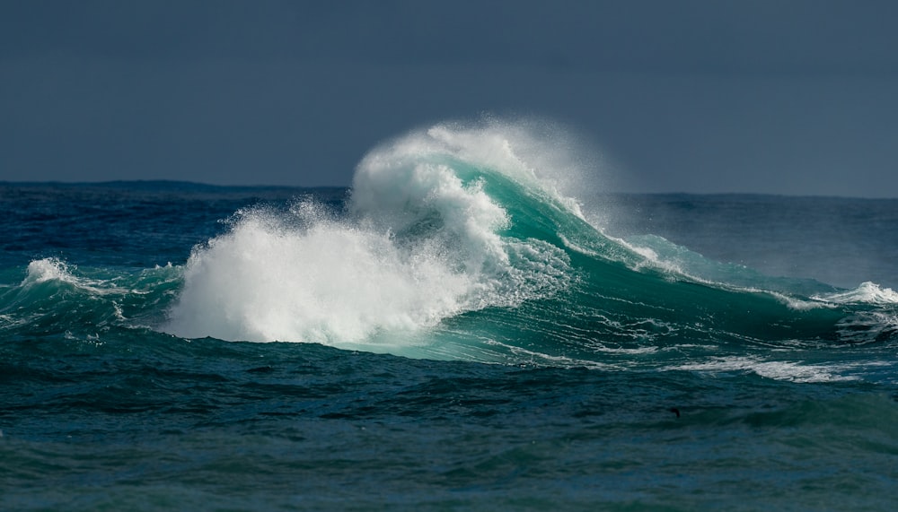 a large wave in the middle of the ocean