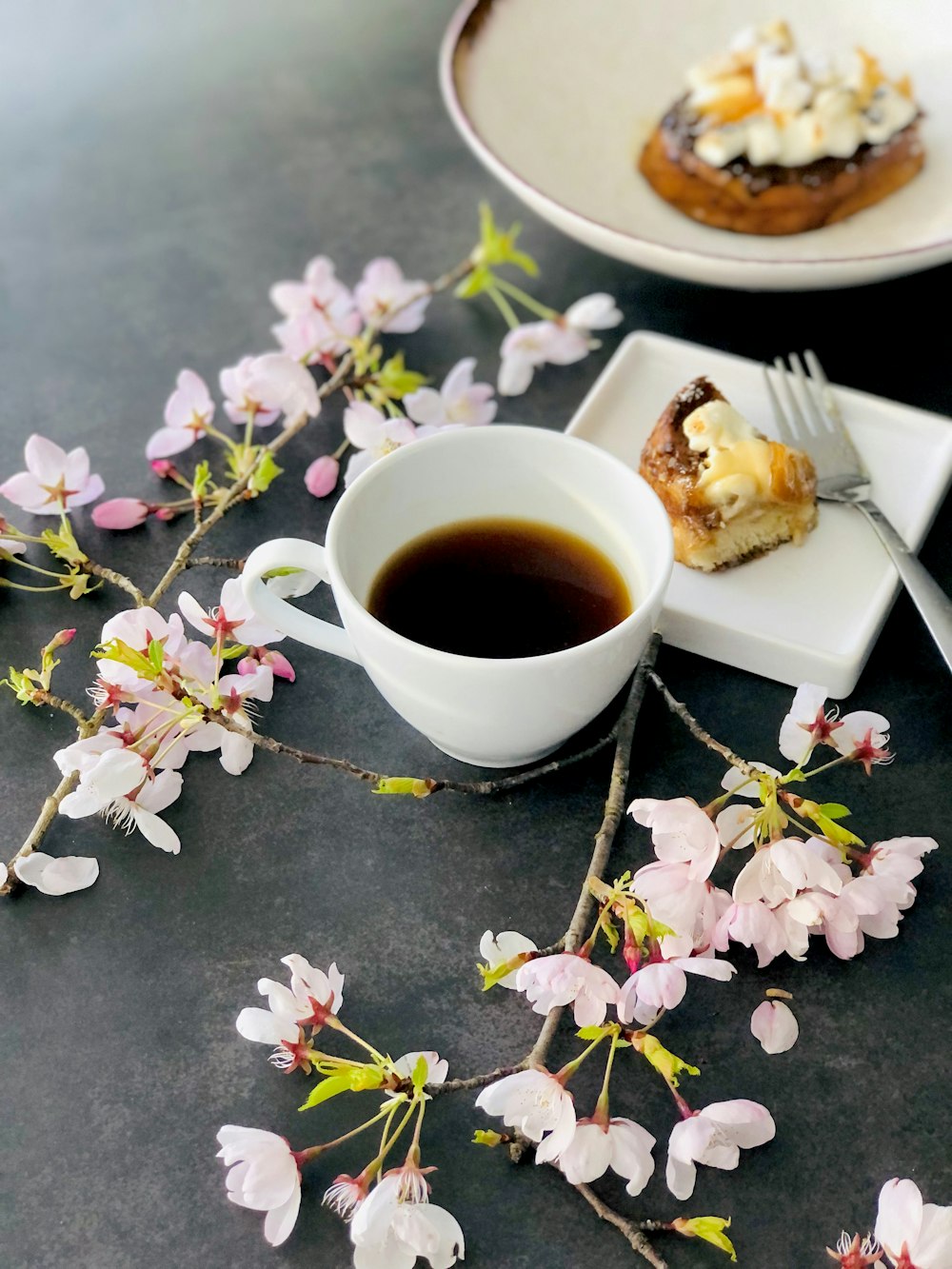 a cup of coffee and a pastry on a plate