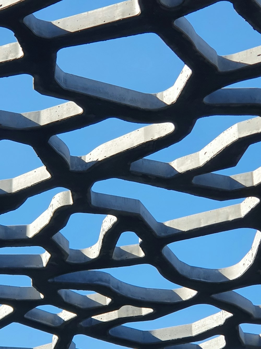 a close up of a metal structure with a blue sky in the background