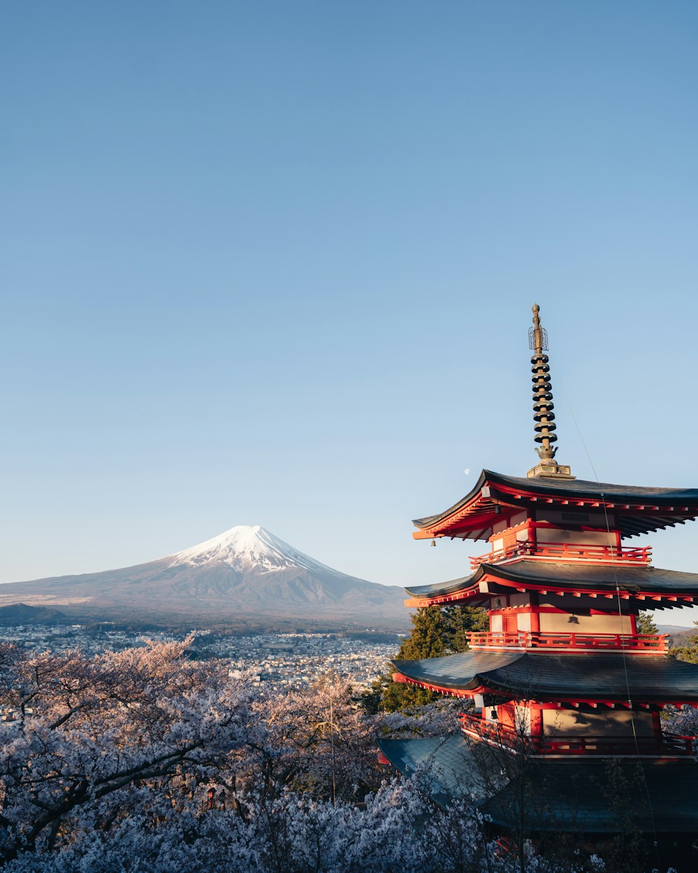 a tall pagoda with a mountain in the background