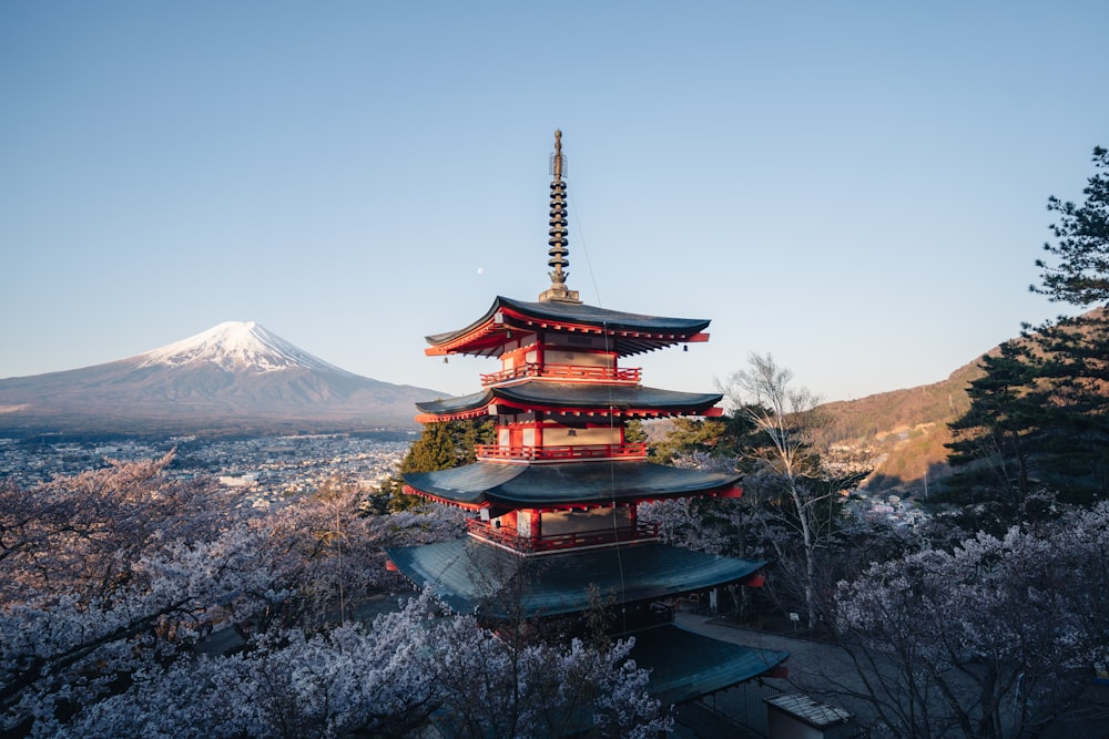 a tall pagoda with a mountain in the background