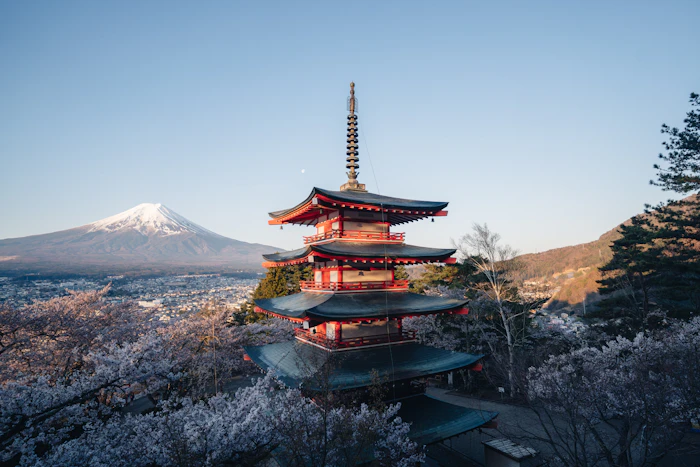 A tall pagoda with Mount Fuji in the background