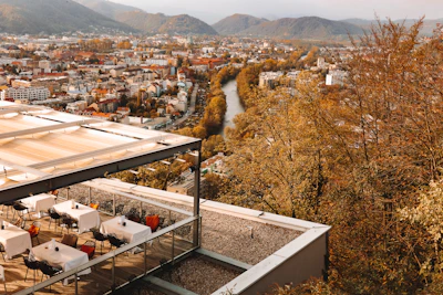 Rooftop terrace with lounge seating and a view of the Danube River.