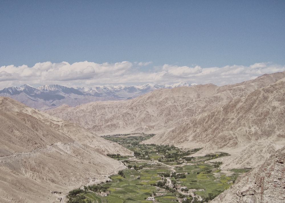 a scenic view of a valley in the mountains