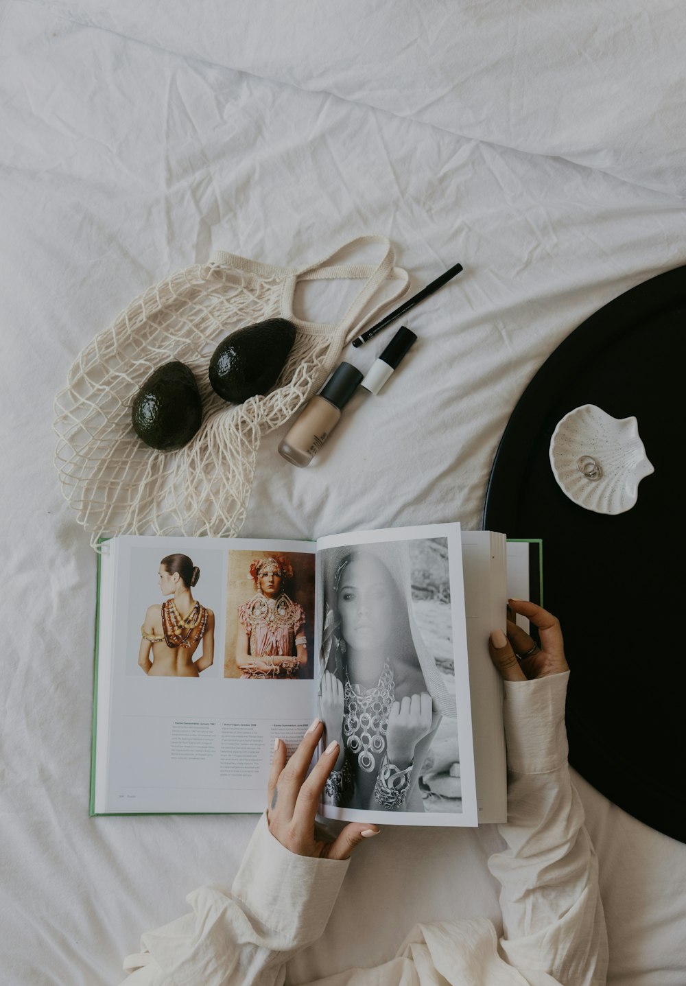 a person laying on a bed reading a book