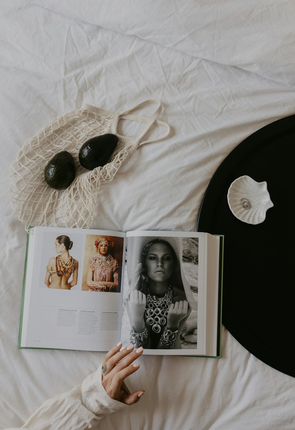 a person laying on a bed reading a book