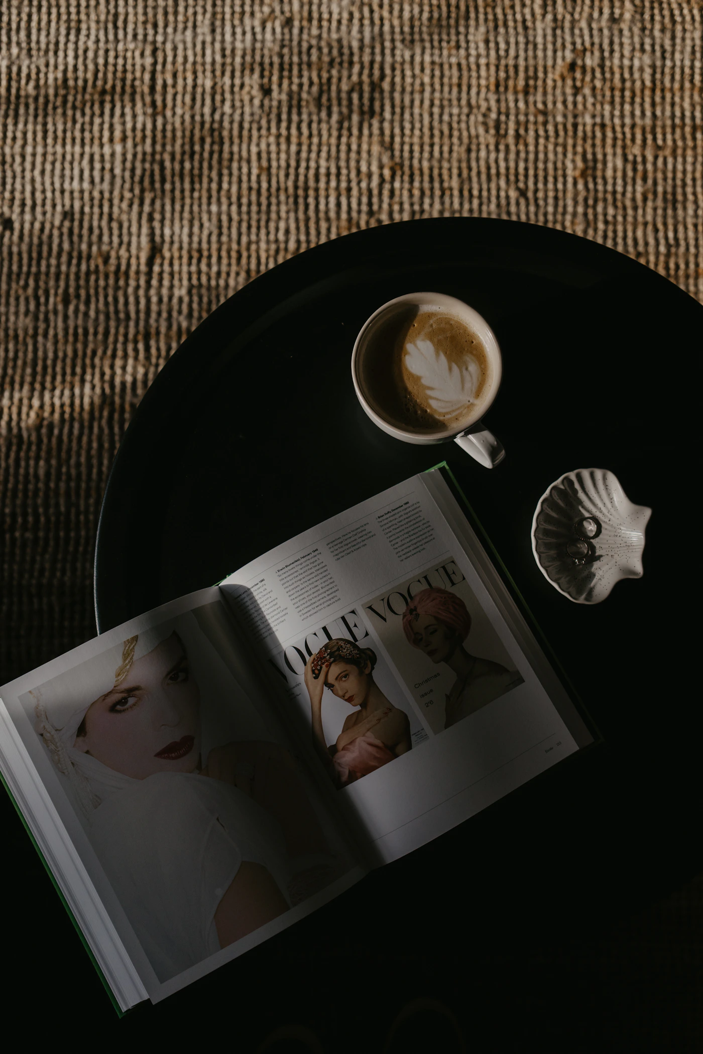 Open printed magazine beside a coffee cup, photographed by Toa Heftiba