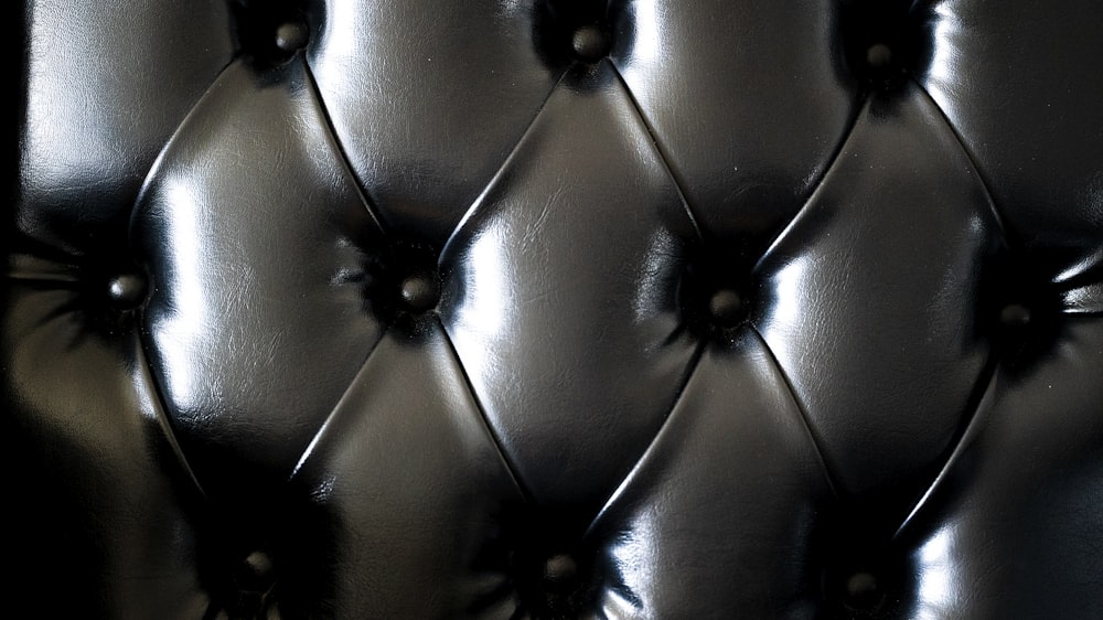 a close up of a black leather upholstered wall