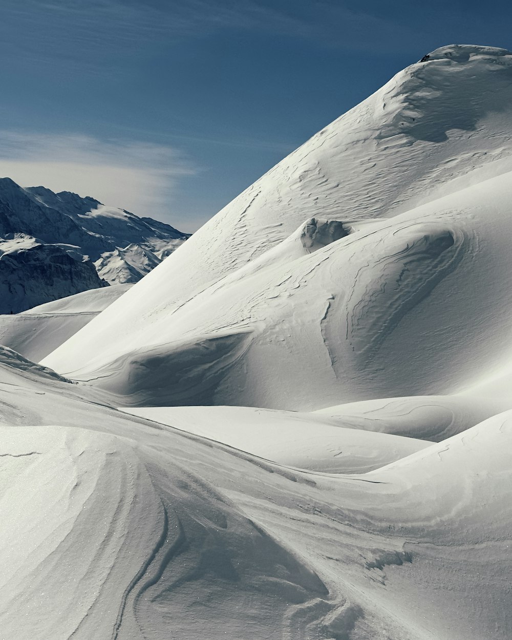 a man riding skis down a snow covered slope