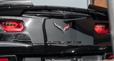 Side profile of a C8 Corvette fitted with a Revolver Aero Dynamics rear diffuser under bright Southern California sunlight.
