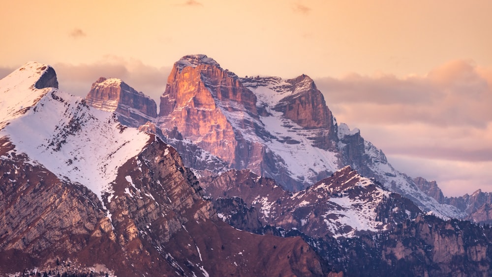 a mountain range with snow covered mountains in the background